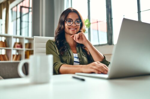 A dietitian working at her laptop on an online revenue stream.