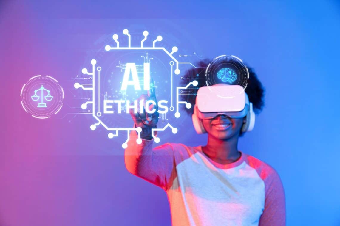 An individual with a virtual reality set reaching out to highlight text that says AI ethics.